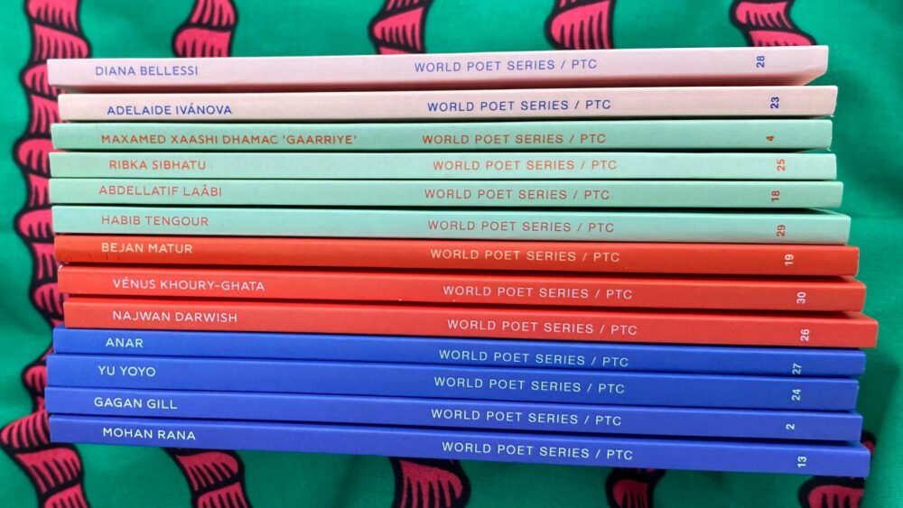 A collection of the PTC's World Poets Series titles, spines-up: a colourful assortment of pink, green, red and blue